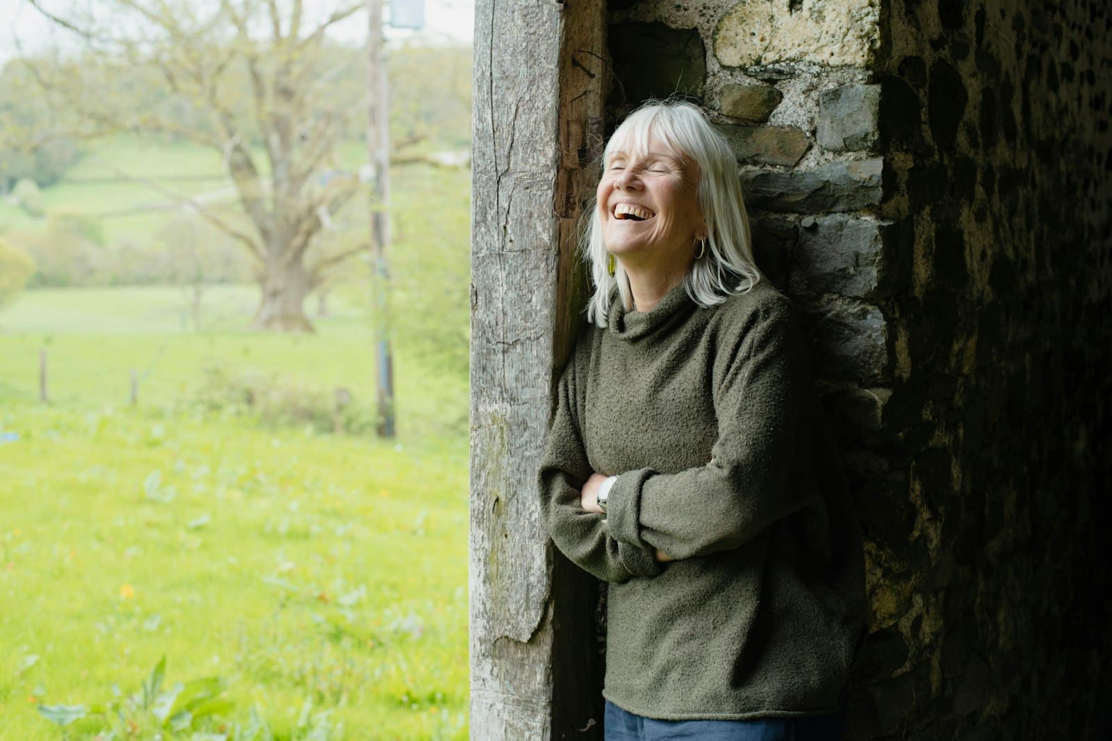 A woman in her 80s smiling outdoors